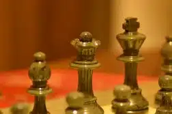 stainless steel chess piece on white table