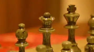 stainless steel chess piece on white table