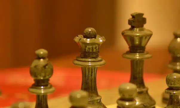 stainless steel chess piece on white table