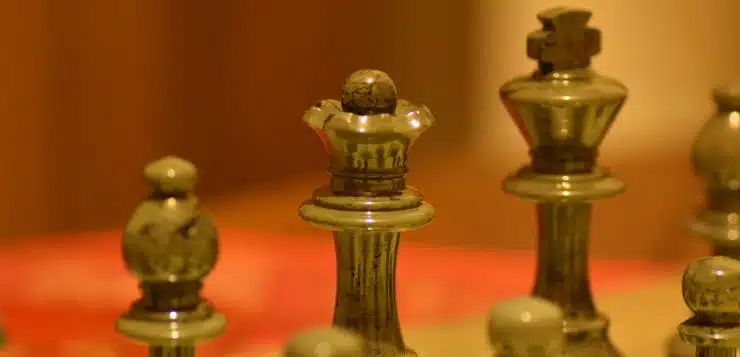 stainless steel chess piece on white table