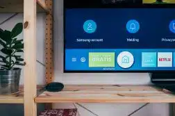 black flat screen tv on brown wooden tv rack